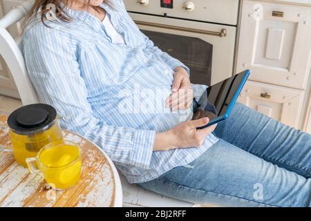 Female enjoys staying at home - watching movie, drinking tea Stock Photo