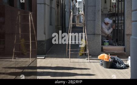 Buenos Aires, Argentina - May 03 2016: Employee of the recoleta cemetery painting a vault Stock Photo