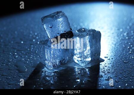 Melting ice cubes under blue light, close up Stock Photo - Alamy