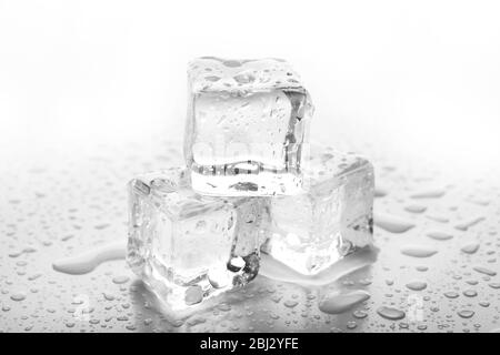 Melting ice cubes on grey background Stock Photo