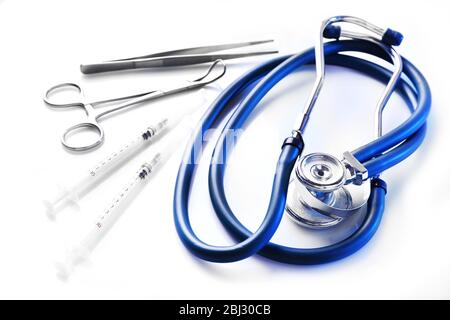 Stethoscope and surgery instruments on white background, close up Stock Photo