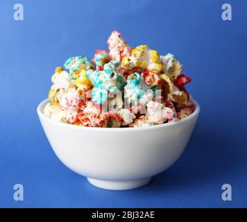 Sweet colourful popcorn on blue background Stock Photo