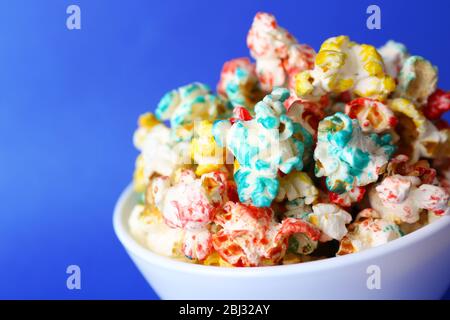 Sweet colourful popcorn on blue background Stock Photo