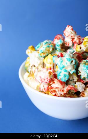 Sweet colourful popcorn on blue background Stock Photo