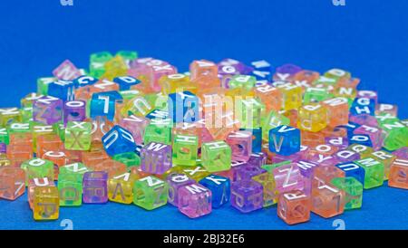 toy beads in different transparent colors with letters on Stock Photo