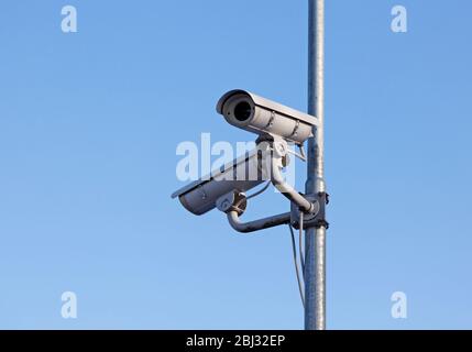 white camera on lamp post