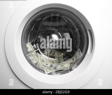 Laundering of dirty money in washing machine, close up Stock Photo