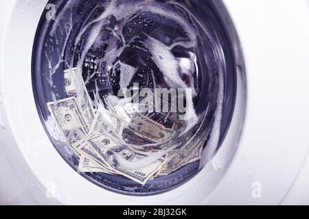 Laundering of money in washing machine, close up Stock Photo