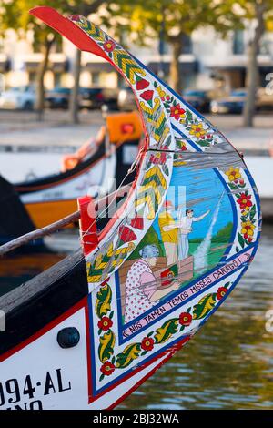 Traditional brightly painted gondola style moliceiro canal boat with painted prow in Aveiro, Portugal Stock Photo