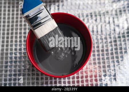 Paint brush and a bucket with paint still life. Painting house outside. Home renovation. Nobody Stock Photo