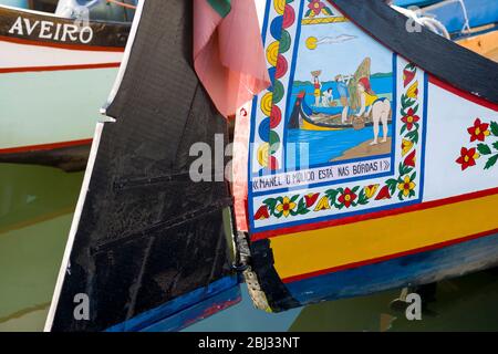 Traditional brightly painted gondola style moliceiro canal boat with saucy scene painted on prow in Aveiro, Portugal Stock Photo