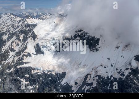 aerial, from a glider, with snow landslides at Selwyn glacier, shot in bright spring light from north-east, Canterbury, South Island, New Zealand Stock Photo