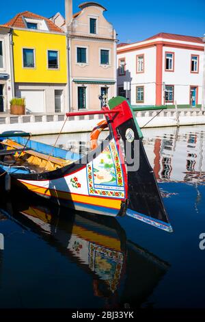 Traditional brightly painted gondola style moliceiro canal boat with saucy scene painted on prow in Aveiro, Portugal Stock Photo