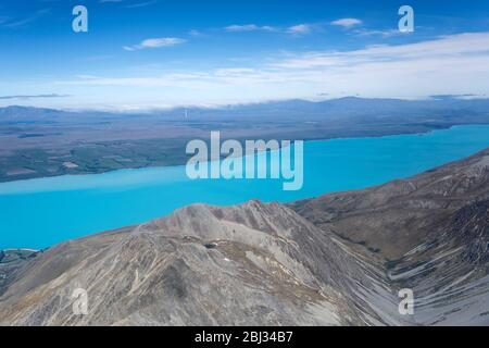 aerial, from a glider, of another glider flying over Ben Oahu range barren slopes near Pukaki lake, shot in bright spring light from west, Canterbury, Stock Photo