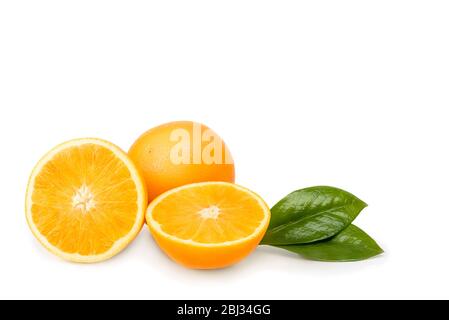 Orange whole and cut into halves with leaves. Isolated on a white background Stock Photo
