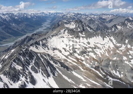 aerial, from a glider, with steep rocky slopes of Ben Oahu range and Dobson river valley, shot in bright spring light from south, Canterbury, South Is Stock Photo