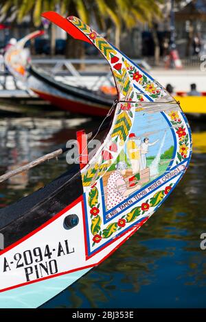 Traditional brightly painted gondola style moliceiro canal boat with scene painted on prow in Aveiro, Portugal Stock Photo