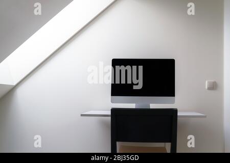Computer with blank screen on the desk at home office. Working from home, isolation. Nobody Stock Photo