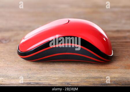 Wireless computer mouse on wooden background Stock Photo