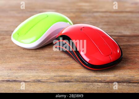 Wireless computer mouses on wooden background Stock Photo
