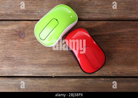 Wireless computer mouses on wooden background Stock Photo