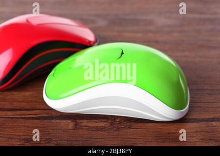 Wireless computer mouses on wooden background Stock Photo