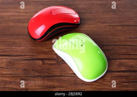Wireless computer mouses on wooden background Stock Photo