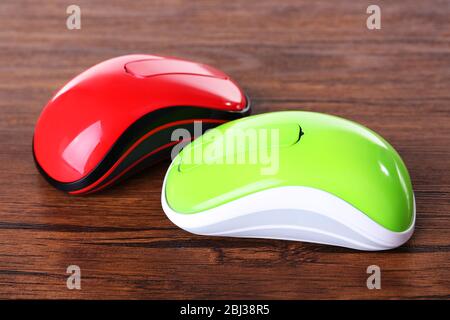 Wireless computer mouses on wooden background Stock Photo