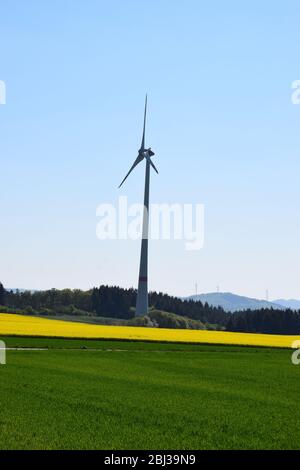 wind energy generation over spring fields Stock Photo