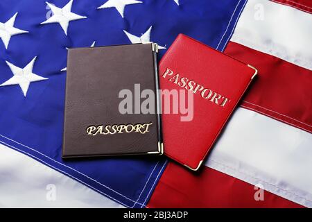 Passports lying on American Flag background Stock Photo