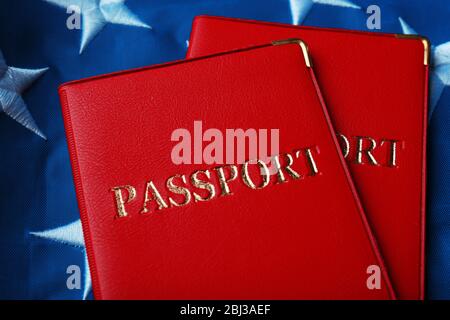 Passports lying on American Flag background Stock Photo