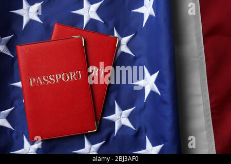 Passports lying on American Flag background Stock Photo