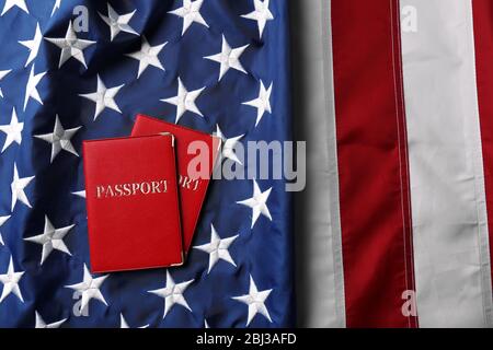 Passports lying on American Flag background Stock Photo