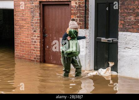 Heavy floods in York city centre where brave residents try to get on with their lives. Stock Photo