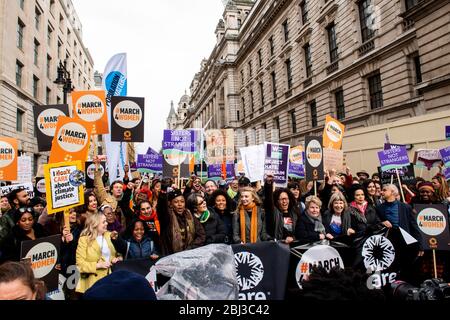 The crowd march towards Parliament Square to celebrate International Women's Day with Sadiq Khan Bianca Jagger and Sandi Toksvig at the front. Stock Photo