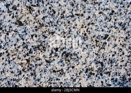The texture of light pink natural granite with black spots Stock Photo