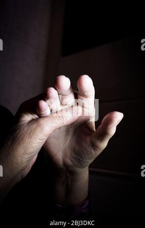 Hands of elderly woman doing a selfmassage. Manual physiotherapy Stock Photo