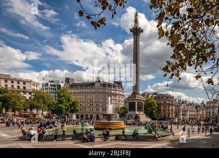 London / UK - September 15 2018: People enjoy the sunshine in Trafalgar Square. Stock Photo