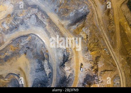 Mining from above. Industrial terraces on open pit  mineral mine. Aerial view of opencast mining. Dolomite Mine Excavation. Extractive industry. Giant Stock Photo