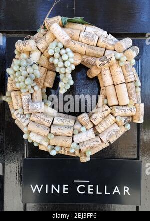 A decorative cork wreath with plastic grapes, creative use of old wine corks made into an ornament for the entrance to a wine cellar, great idea for w Stock Photo