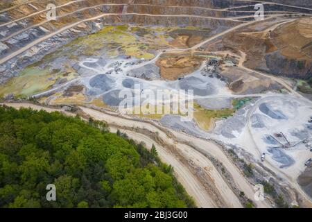 Mining from above. Industrial terraces on open pit  mineral mine. Aerial view of opencast mining. Dolomite Mine Excavation. Extractive industry. Giant Stock Photo