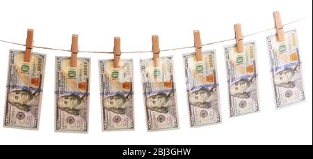 Concept of money laundering - dollars are drying on cord isolated on white background