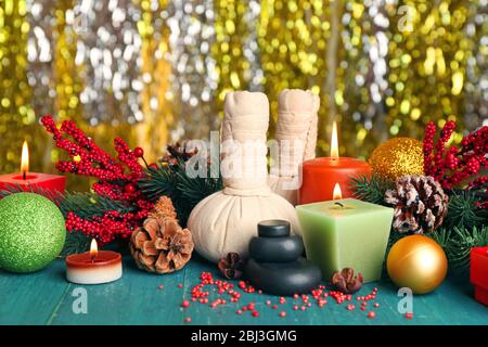 Beautiful Christmas presents composition on green wooden table against sparkle background, close up Stock Photo