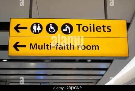 Toilets and Multi Faith Room Sign at an Airport Terminal Stock Photo