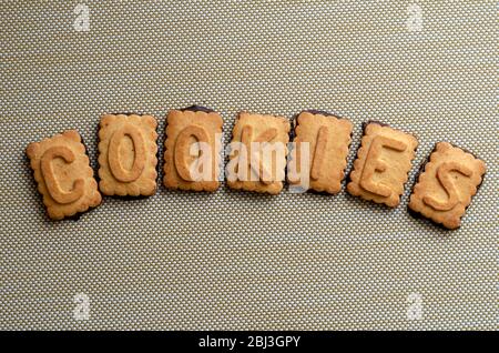 Cookies word spelled out with cookie letters. Seven cookies with the alphabet layered in one word. Sweet treats for educating children. Copy space. Cl Stock Photo