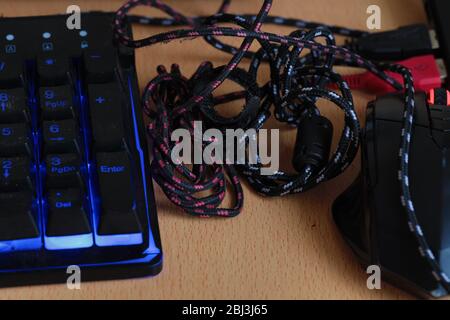 Concept consisting of mouse, keyboard and cables. Cables tangled ...