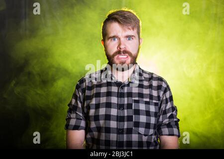 Portrait of strange man making stupid angry face Stock Photo