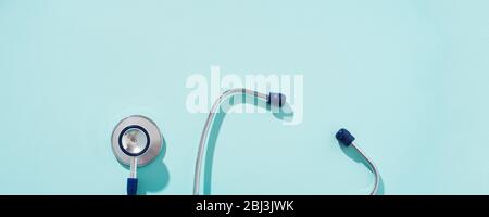 Phonendoscope on empty blue background, place for inscription. Concept of medivine. Stock Photo