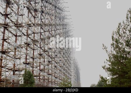 Secret Soviet Radar 'DUGA-1', called a woodpecker hidden in the forest in the nearby of Prypiat city. Tall metal construction spreading on a wast terr Stock Photo