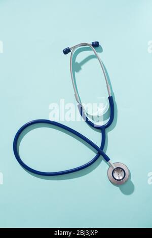 Phonendoscope on empty blue background, place for inscription. Concept of medivine. Stock Photo